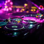 DJ console desk at nightclub, party, bright neon pink lights