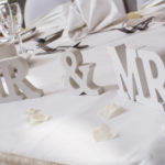 White wooden Mr & Mrs sign on the top table in the Ballroom on the Park at Mercure Leeds Parkway Hotel