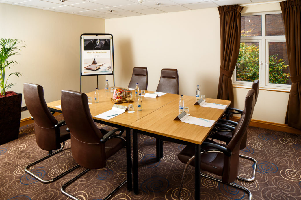 The Birch meeting room at Mercure Leeds Parkway Hotel, high-backed leather chairs around a wooden table
