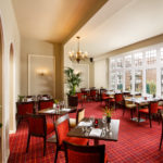 The Brasserie restaurant at Mercure Leeds Parkway Hotel, tables by the window looking out onto the grounds