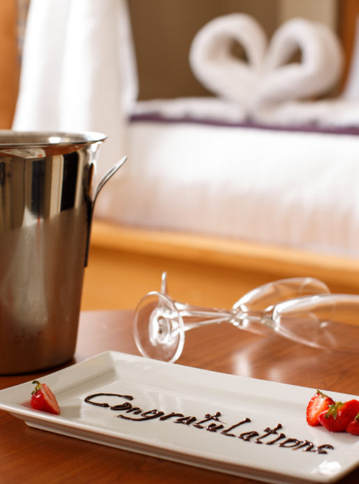 Champagne and roses congratulating newly married couple in the Superior Room Bridal Suite at Mercure Leeds Parkway Hotel