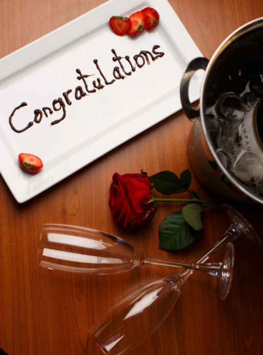 Champagne and roses congratulating newly married couple in the Superior Room Bridal Suite at Mercure Leeds Parkway Hotel